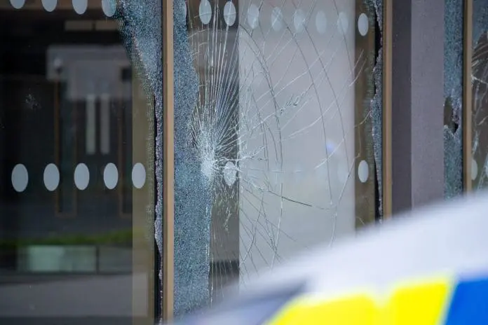 A,Shattered,Window,Caused,By,Criminal,Damage,During,A,Riot.
