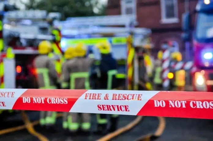 Fire,Brigade,Place,Cordon,Tape,Around,A,Suspected,Arson,Scene
