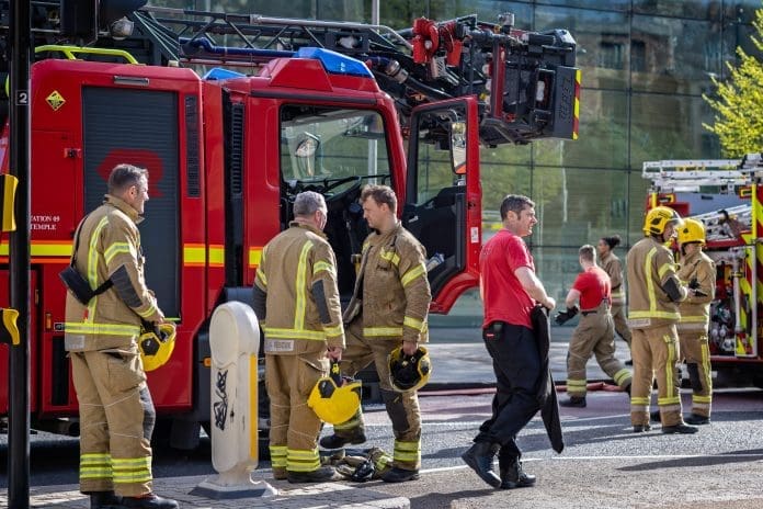 Group,Of,Firemen,Beside,A,Fire,Engine,Having,Put,Out