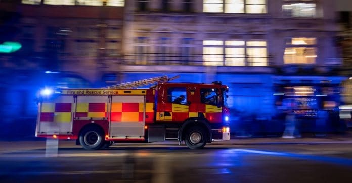 Fast-moving,Fire,Truck,With,Sirens,On,,Racing,Through,Downtown,Streets